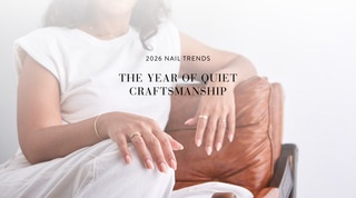 image of a woman relaxing in a chair with natural, almond shape nail extensions. Text reads: 2026 nail trends: the year of quiet craftsmanship